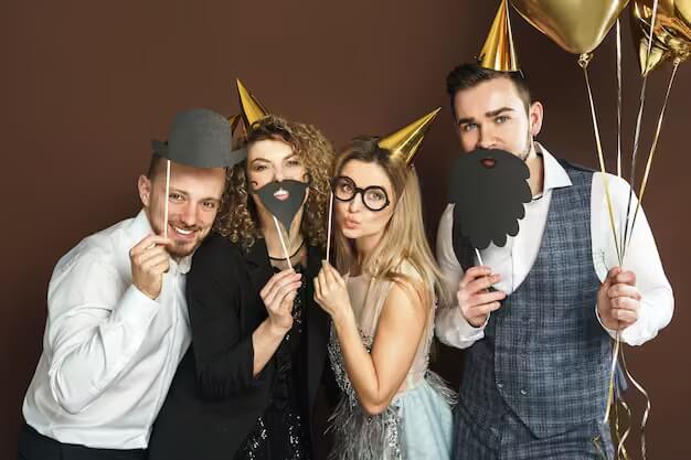 group-happy-people-wearing-party-hats-with-funny-photo-booth-props-are-celebrating-holiday-event_144962-14912.jpg