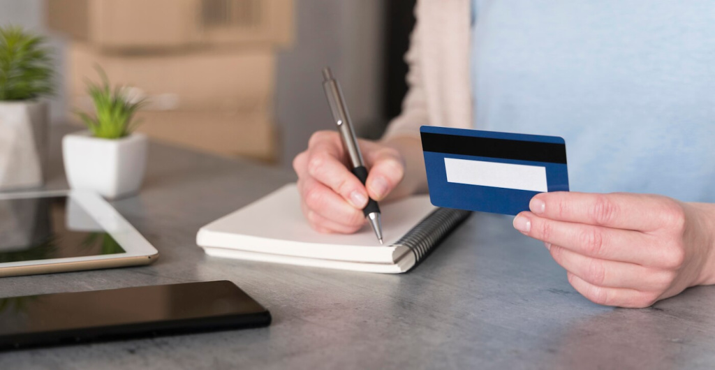 high-angle-woman-holding-credit-card-writing-notepad.jpg high-angle-woman-holding-credit-card-writing-notepad.jpg